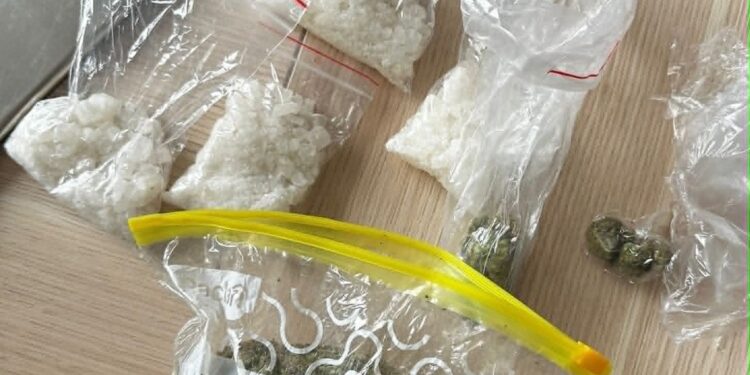 Several Clear Bags Contain White Crystalline Substance on a Wooden Surface with a Few Coins Nearby 7 Maja 2026 