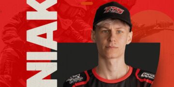 Portrait of a young athlete wearing a black cap and red-and-black jersey, facing the camera against a bold red backdrop with large white text on the left.