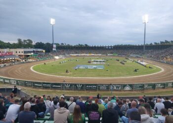 Crowded Outdoor Stadium with a Dirt Race Track Curved Turns and Tall Floodlights Overhead 18 Września 2021