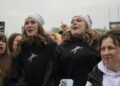 Group of Young People Cheering at an Outdoor Event Two Central Girls Wear White Bandanas and Black Hoodies 15 Czerwca 2020