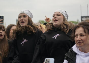 Group of Young People Cheering at an Outdoor Event Two Central Girls Wear White Bandanas and Black Hoodies 5 Sierpnia 2022 