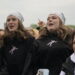 Group of Young People Cheering at an Outdoor Event Two Central Girls Wear White Bandanas and Black Hoodies 15 Czerwca 2020