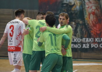 Team of Players in Lime Green Uniforms Hug on an Indoor Court Celebrating During a Match White Jersey with Number 3 Visible on Left 17 Maja 2024 