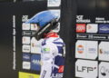 Motorsport Rider in a Blue Helmet and White Racing Suit Stands at a Sponsor filled Pit Wall 16 Czerwca 2020  ml 5067