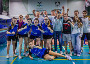 a Group of Athletes and Coaches Posing for a Team Photo in an Indoor Sports Hall Many Raising Fists and Smiling 23 Czerwca 2019
