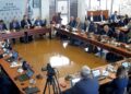 City Council Meeting with Officials Seated Around a U shaped Table Laptops and Microphones in Use a Camera Recording the Session in Progress 15 Czerwca 2020