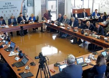 City Council Meeting with Officials Seated Around a U shaped Table Laptops and Microphones in Use a Camera Recording the Session in Progress 1 Listopada 2020