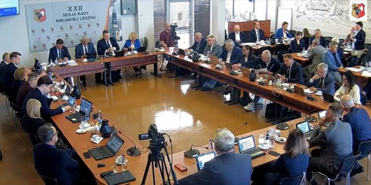 City Council Meeting with Officials Seated Around a U shaped Table Laptops and Microphones in Use a Camera Recording the Session in Progress 11 Czerwca 2026