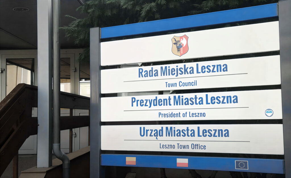 Sign for Rada Miejska Leszna town Council and Prezydent Miasta Leszna president of Leszno with a Crest on a Blue framed Outdoor Sign 9 Września 2025